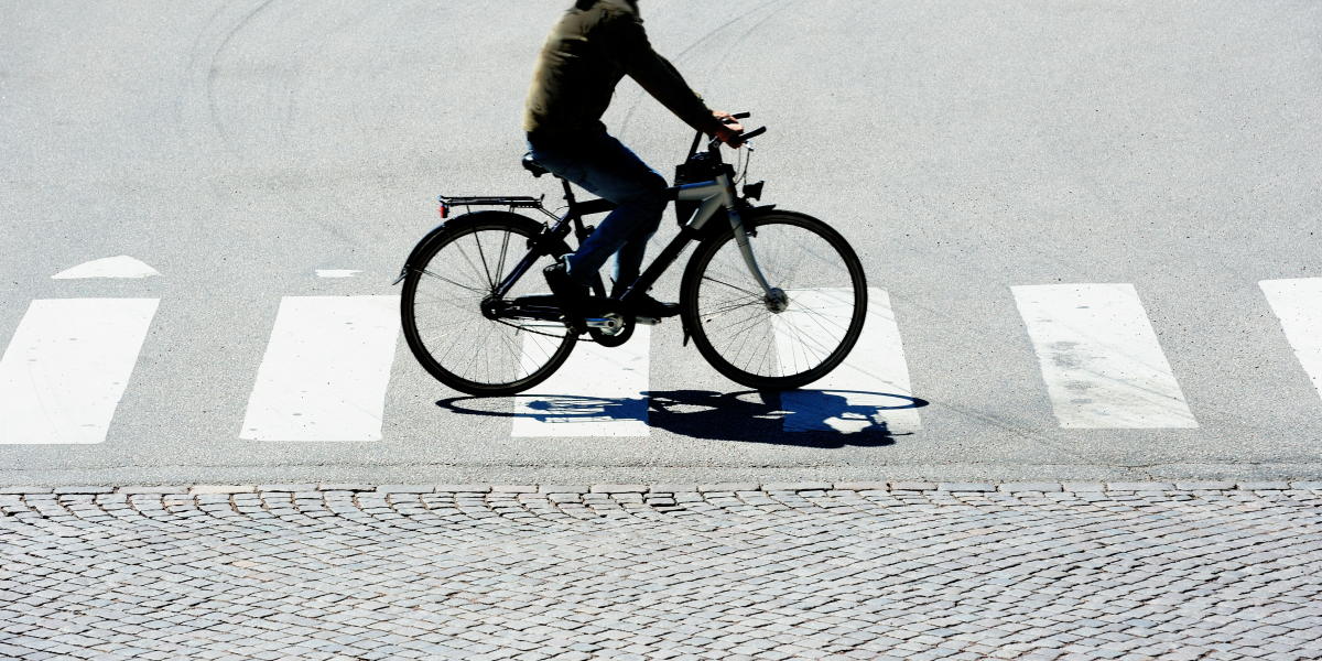 Man cycling on pedestrian crossing.Credit Olaser