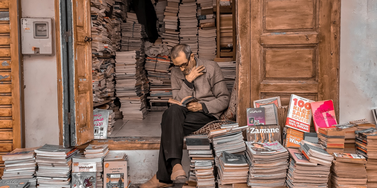 bookseller reading in doorway, Rabat, Morocco