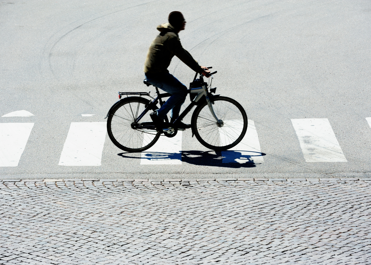Man cycling on pedestrian crossing.Credit Olaser