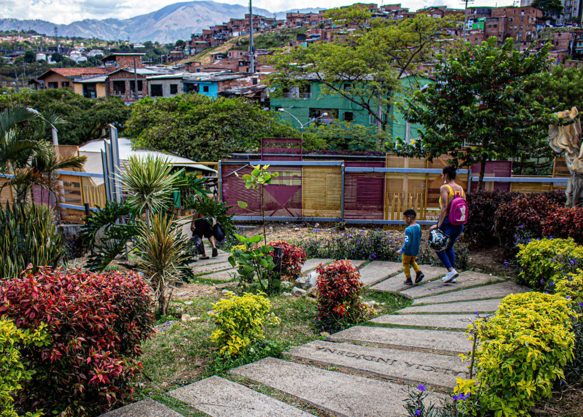 man walks child to school in Medellin