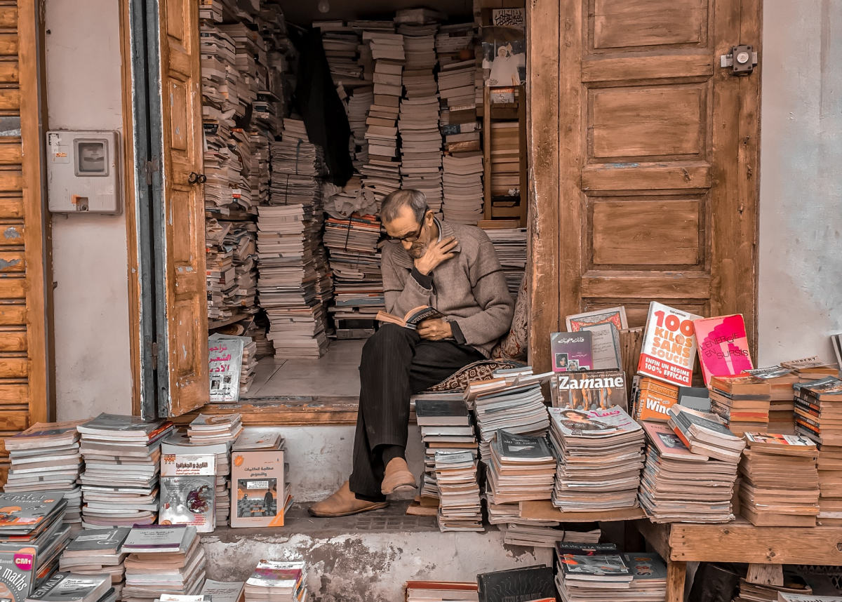 bookseller reading in doorway, Rabat, Morocco