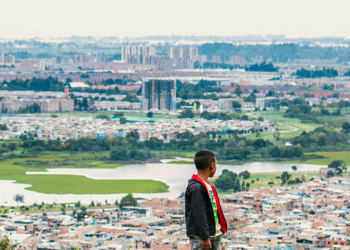 boy looking out at city of Bogota.
